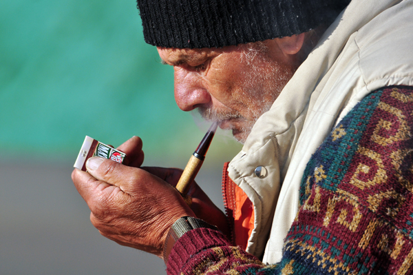 Walt lighting his corncob pipe